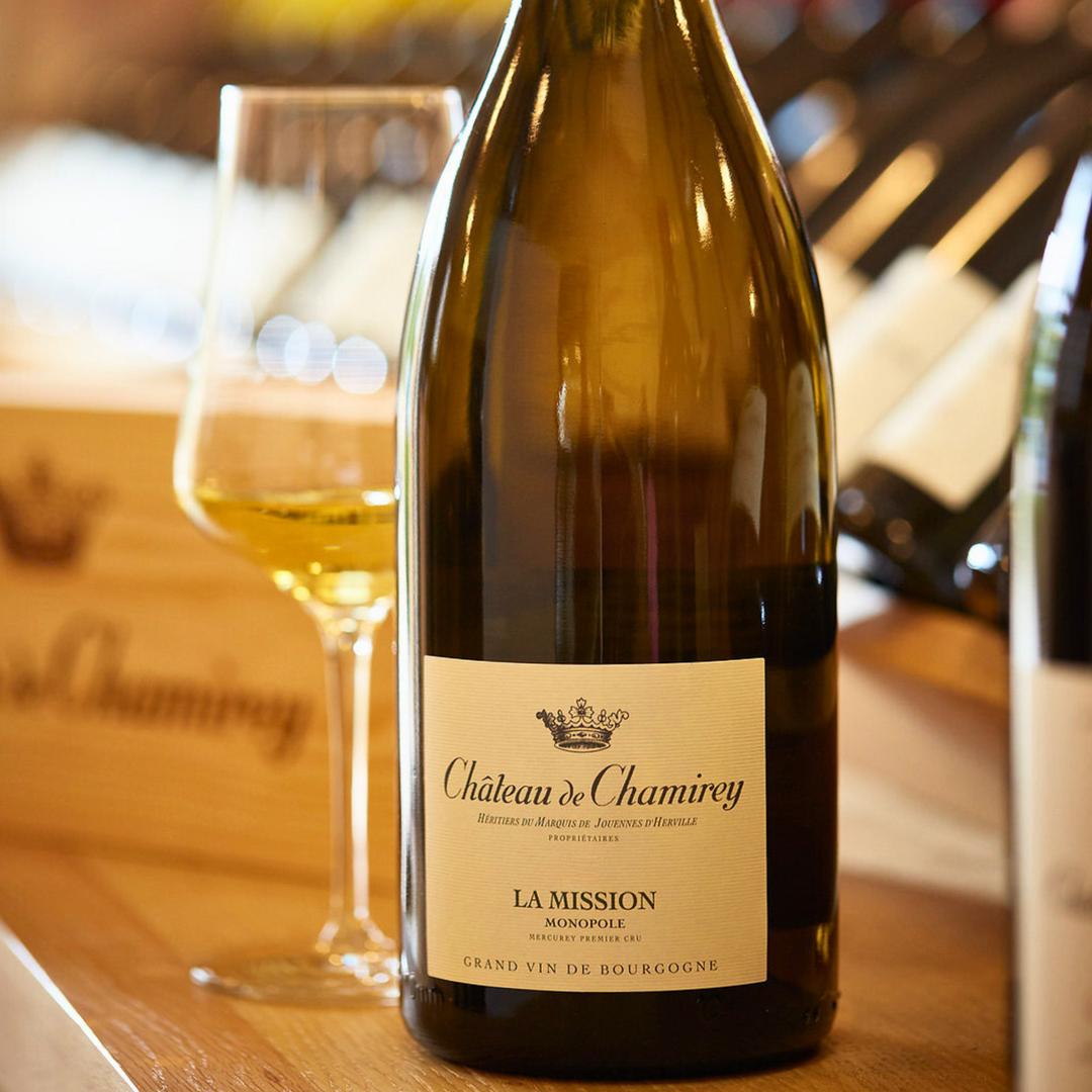 Château de Chamirey La Mission Monopole Mercurey Premier Cru white wine in a magnum bottle, paired with a glass, showcasing its elegant Burgundy craftsmanship.