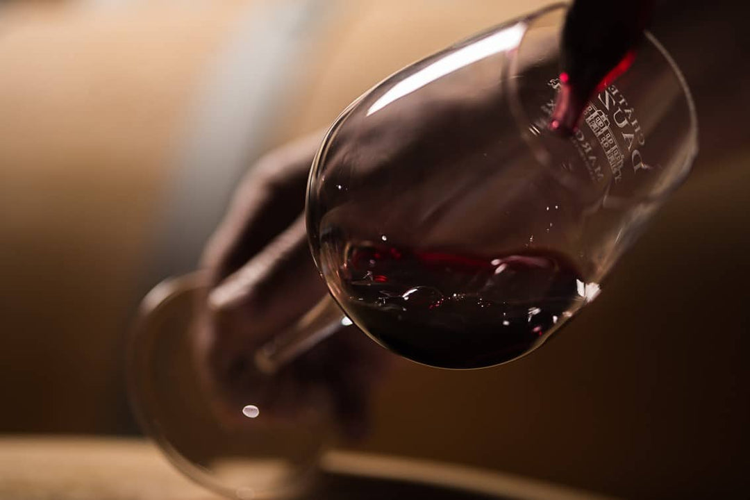 Pouring a glass of red wine from Château Dauzac, a Grand Cru Classé en 1855 estate in Margaux, Bordeaux.