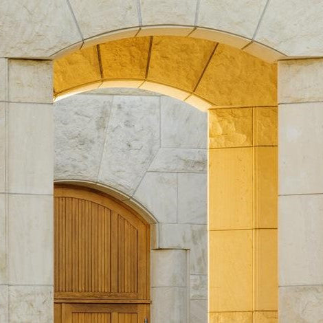 Beautiful limestone archway at Opus One Winery, showcasing elegant architecture with warm golden tones.