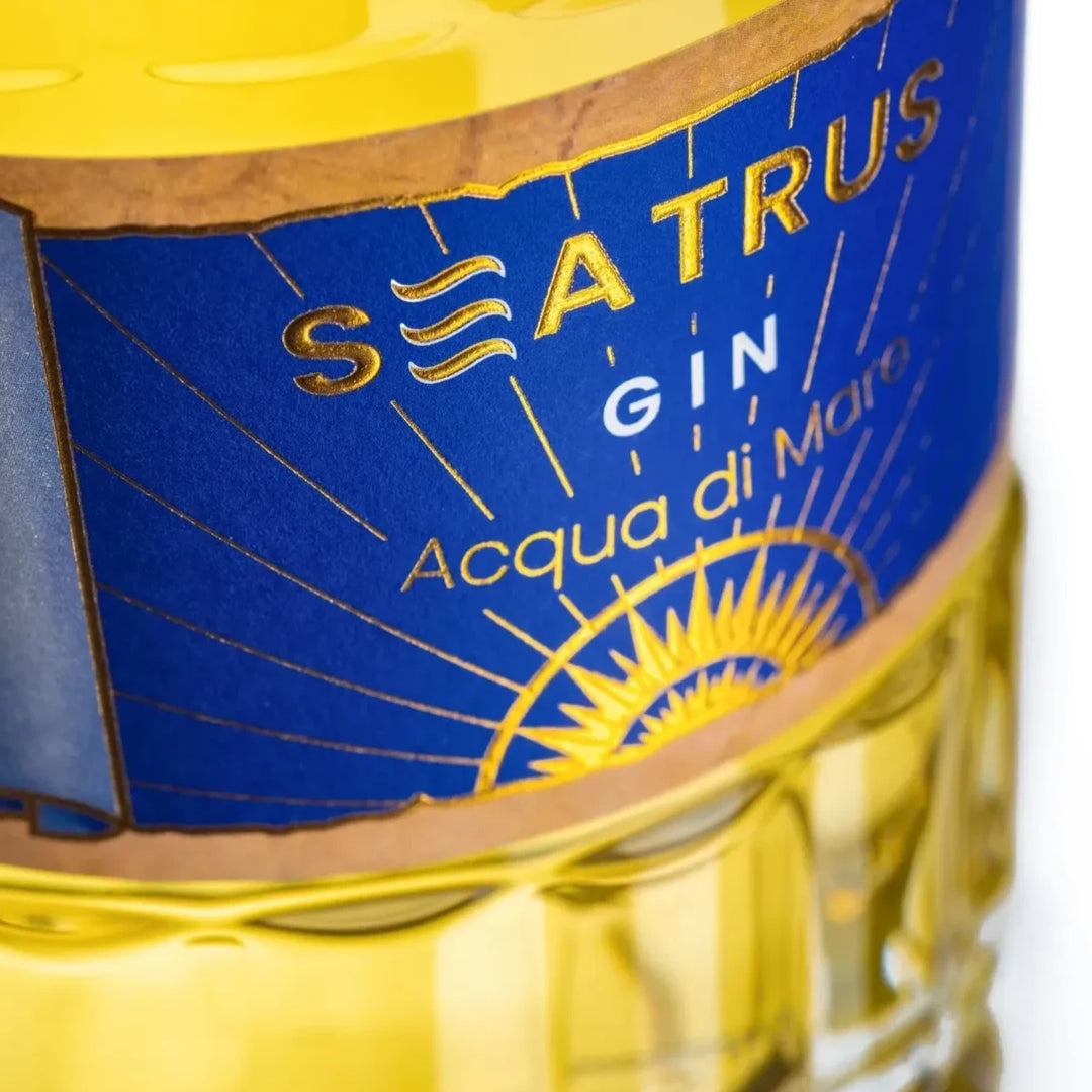 Close-up of the Seatrus Gin Acqua di Mare label, emphasizing the intricate gold and blue design.