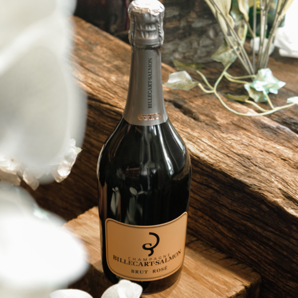 Billecart-Salmon Brut Rosé Champagne bottle beautifully presented on a rustic wooden surface.