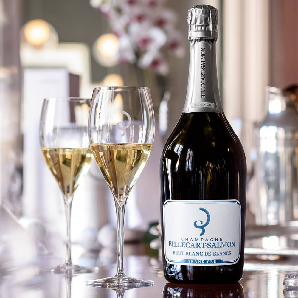 Billecart-Salmon Blanc de Blancs Grand Cru Champagne with glasses in an elegant dining setup.