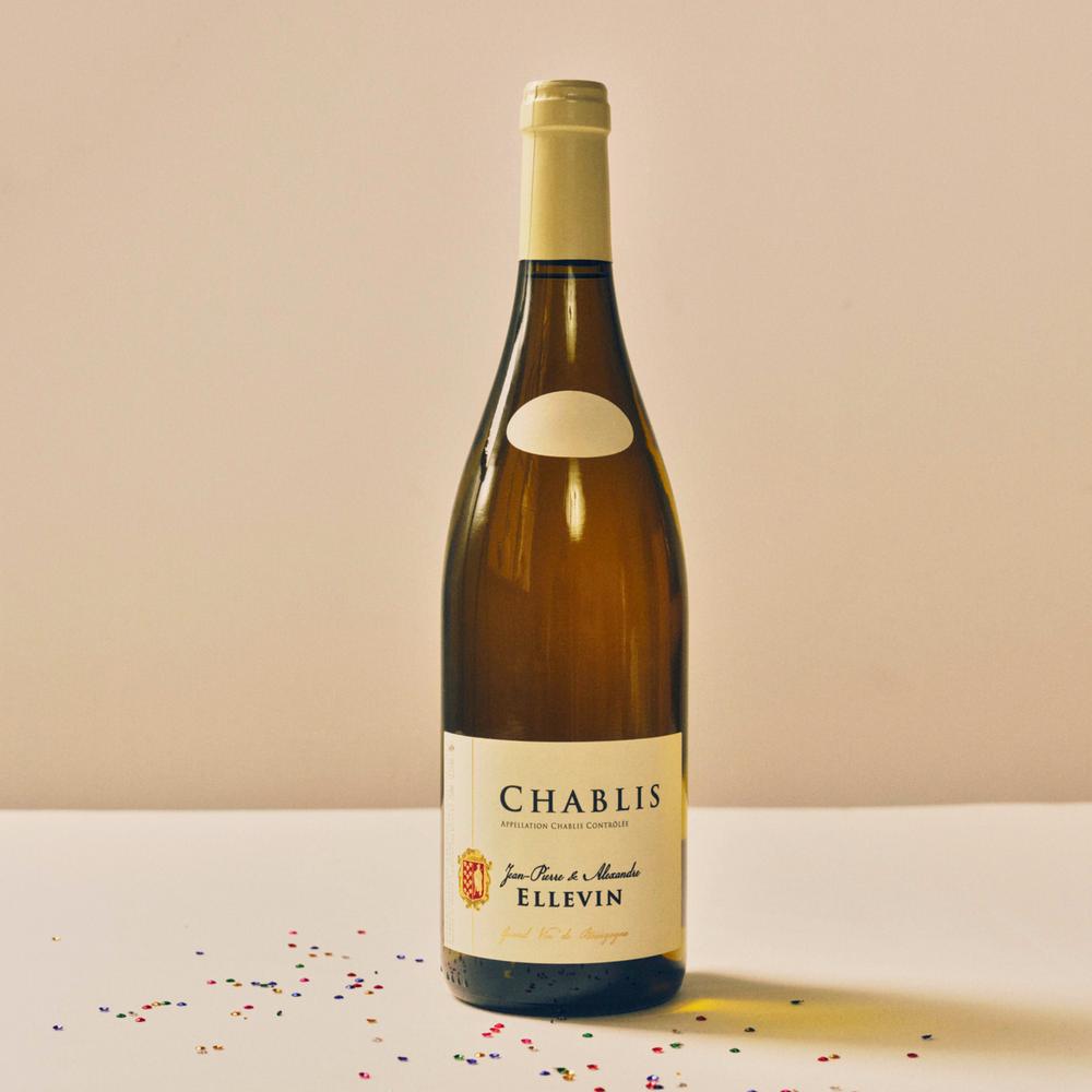 Chablis Jean-Pierre & Alexandre Ellevin white wine bottle with a minimalistic label, displayed against a neutral background with festive confetti.