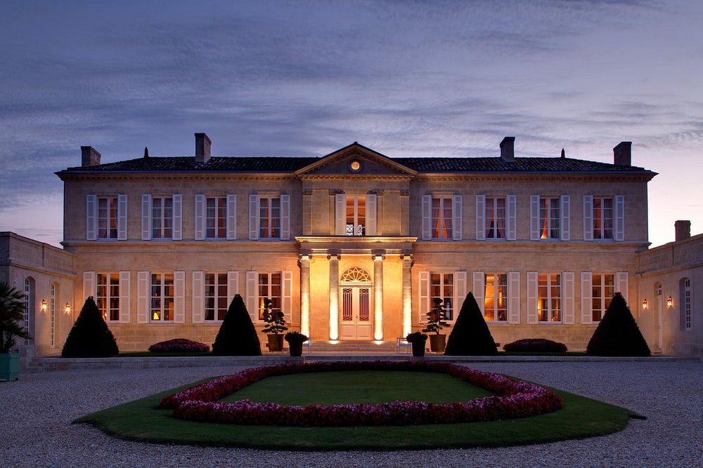 The elegant Château Branaire-Ducru estate at dusk, showcasing its stunning architecture and illuminated facade.