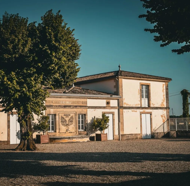 Historic Château Climens estate, a renowned Premier Cru winery in Barsac, Bordeaux, surrounded by trees and rustic charm.