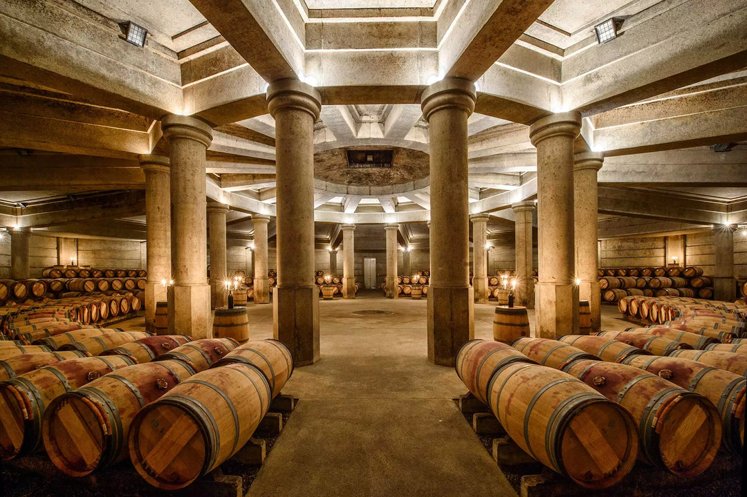 The grand wine cellar of Château Lafite Rothschild, featuring aged barrels and stunning architecture.