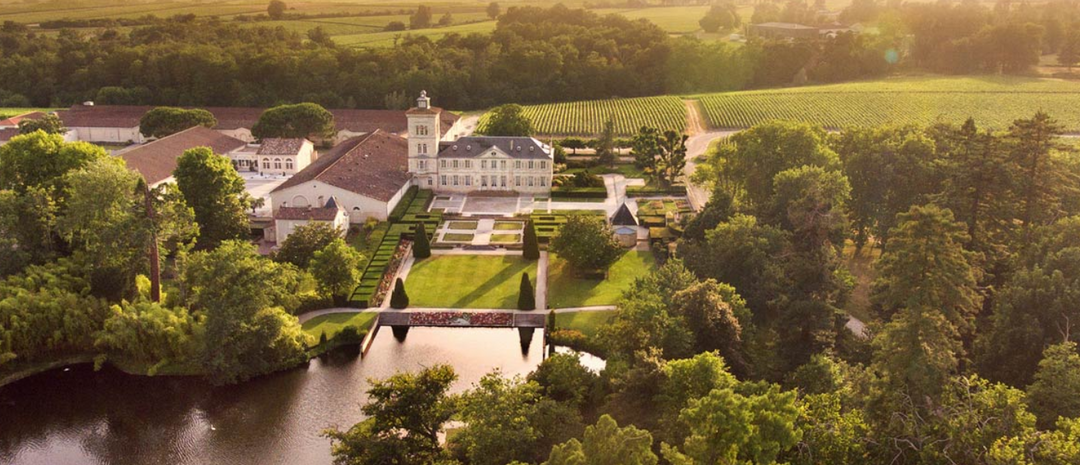 Aerial view of Chateau Lagrange and its surrounding vineyards.