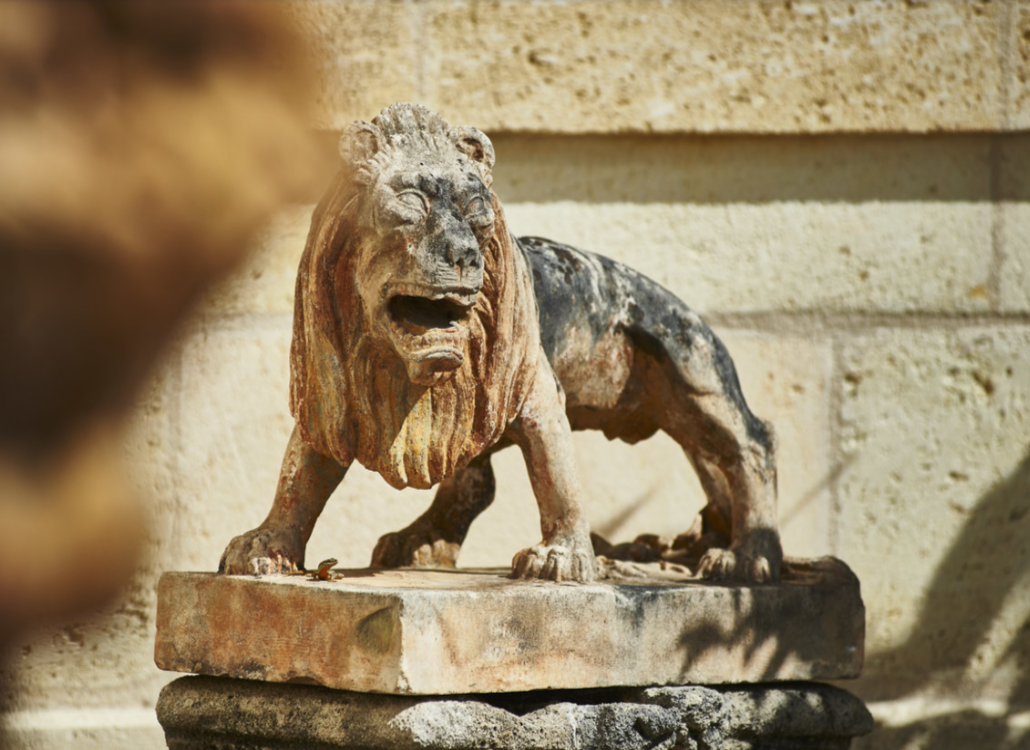 Close-up of the iconic stone lion statue at Chateau Langoa-Barton, showcasing its historic charm.