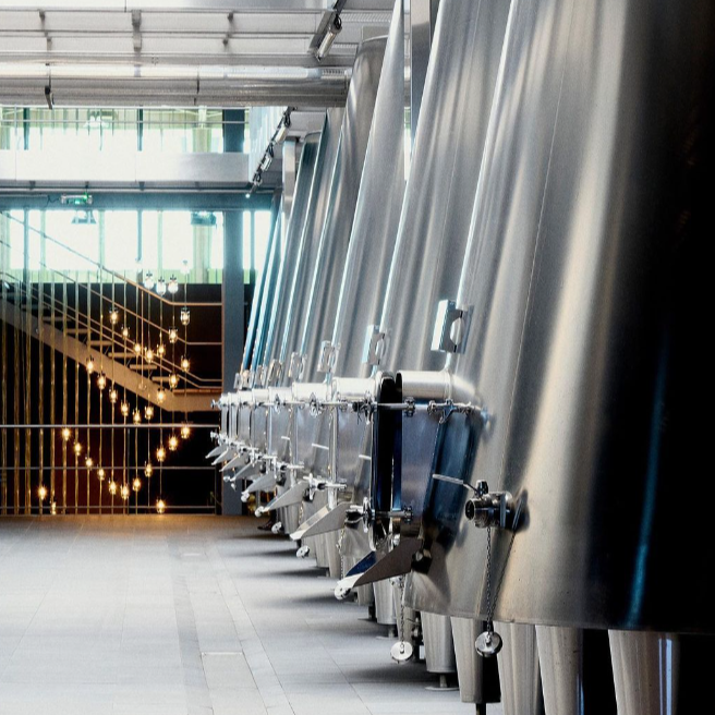 Modern stainless steel vat room at Château Pichon Longueville Comtesse de Lalande, reflecting their innovative winemaking process.