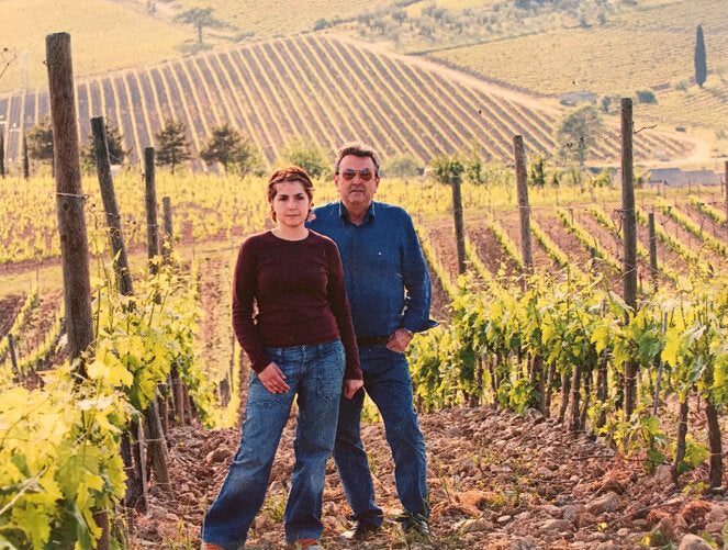 Two winemakers standing in a vineyard at Fanti estate in Montalcino, Tuscany.