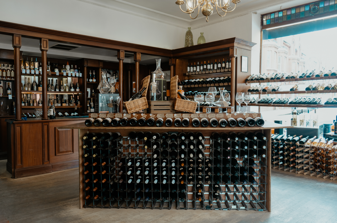 Inside Friarwood Parsons Green wine shop with an elegant wooden display and fine wines.