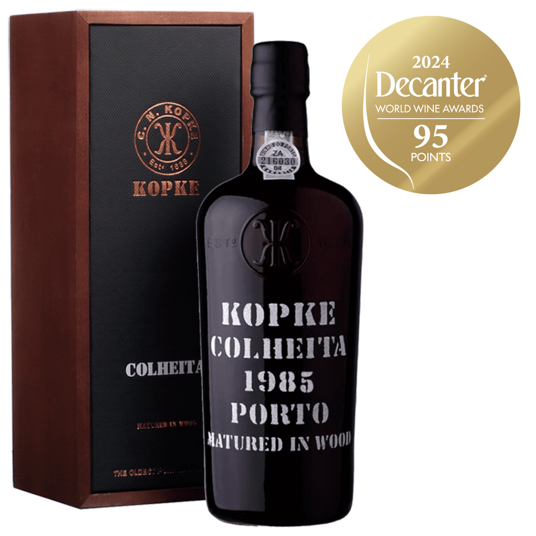 Kopke Colheita 1985 Porto, a premium aged port wine, awarded 95 points by the 2024 Decanter World Wine Awards, presented in a luxury wooden box.