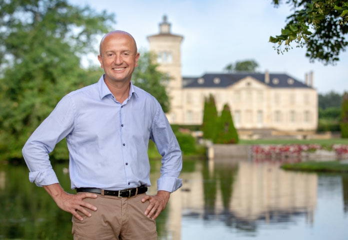 Chateau Lagrange winemaker Mathieu Bordes standing in front of the estate.