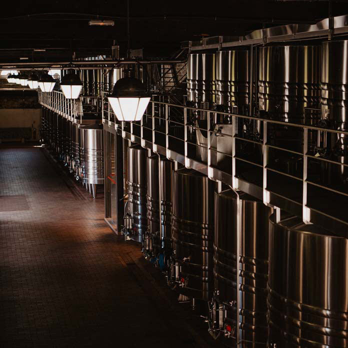 Stainless steel fermentation tanks at Chateau Lagrange winery.