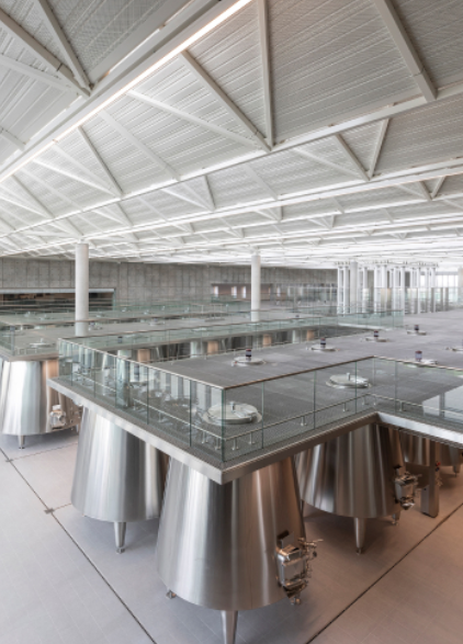 Modern stainless steel tanks inside the Lynch Bages winery production facility.