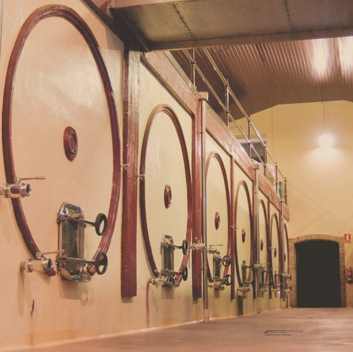 Large fermentation tanks in the wine production area of Marques winery.