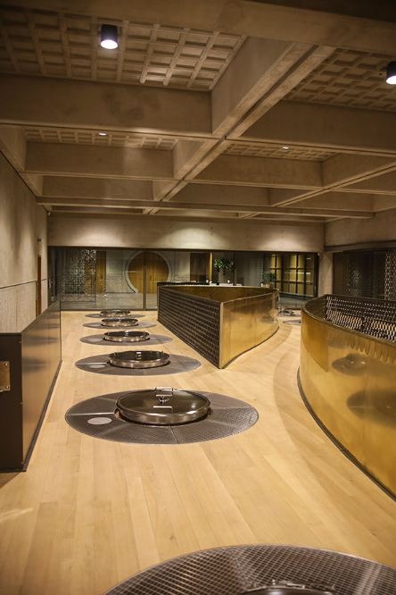 Modern fermentation room at Château Marquis d'Alesme, featuring sleek stainless steel vats.