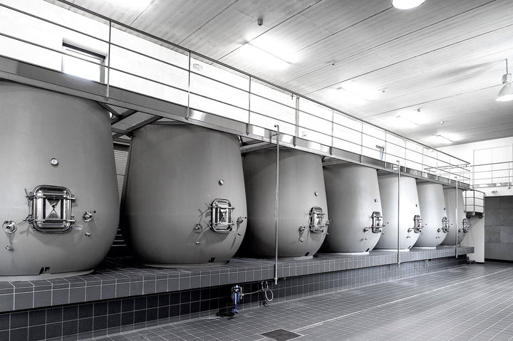 Modern fermentation tanks in a winery, showcasing advanced vinification techniques.