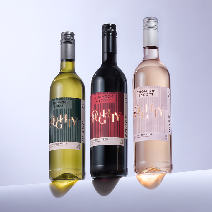 Trio of Noughty Wines—Blanc, Rouge, and Rosé—by Thomson & Scott on a modern display.