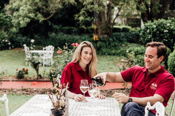 Vincent and Fiona enjoying a glass of wine on the porch at Saxenburg Wine Estate.