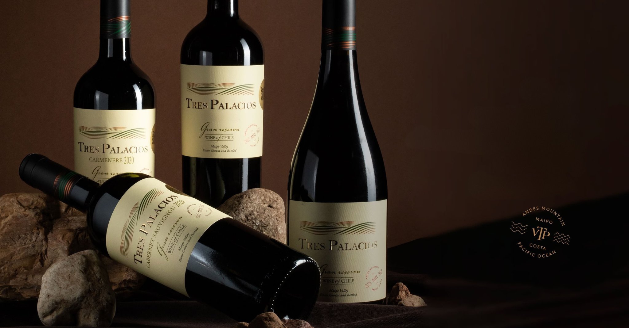 Three bottles of Tres Palacios wine, including Carmenere 2020 and Cabernet Sauvignon, elegantly arranged with a warm, earthy background.