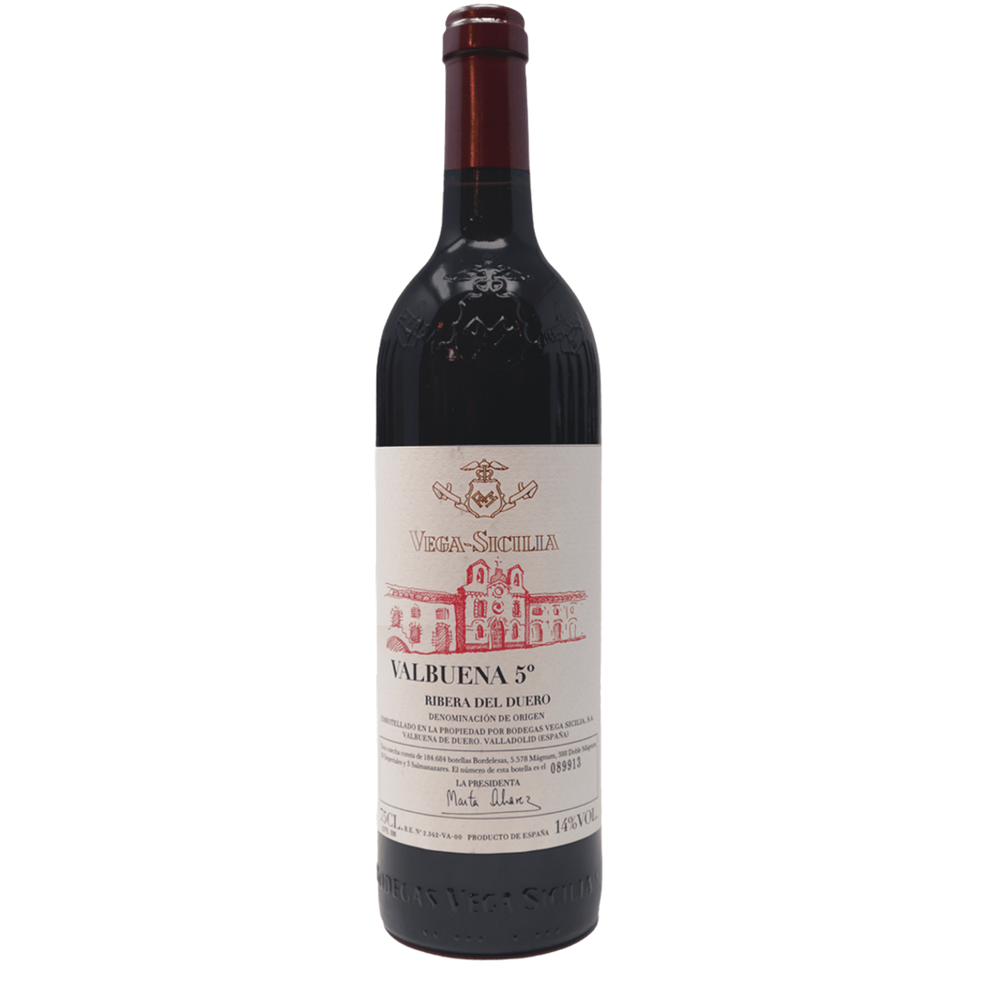 A bottle of Vega Sicilia Valbuena 5°, a prestigious red wine from Ribera del Duero, Spain, featuring a detailed label with the historic winery illustration.