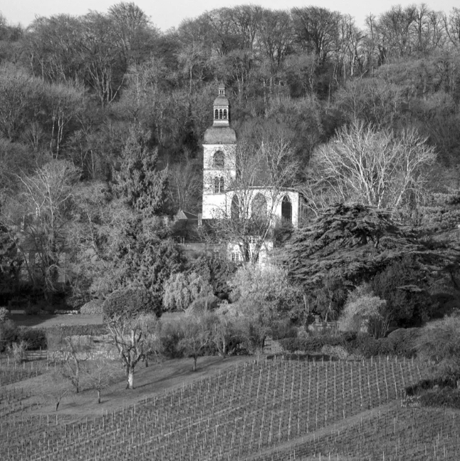  A historic church overlooking vineyards, symbolizing the deep-rooted winemaking tradition of the region.