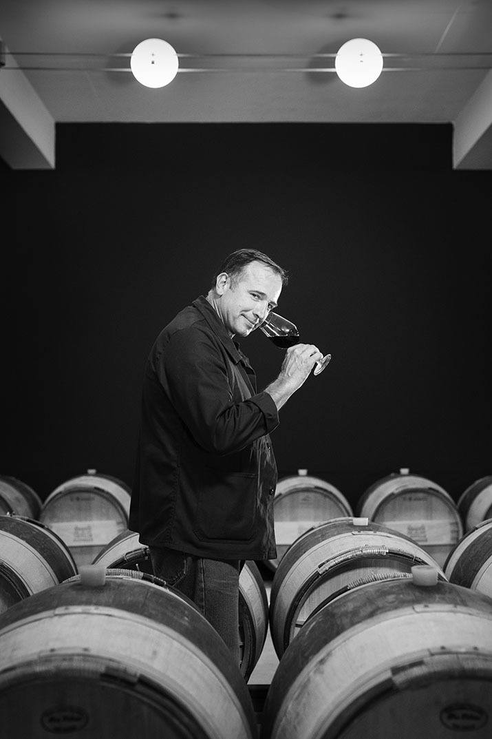 Winemaker tasting wine directly from the barrels at Château Léoville-Poyferré.