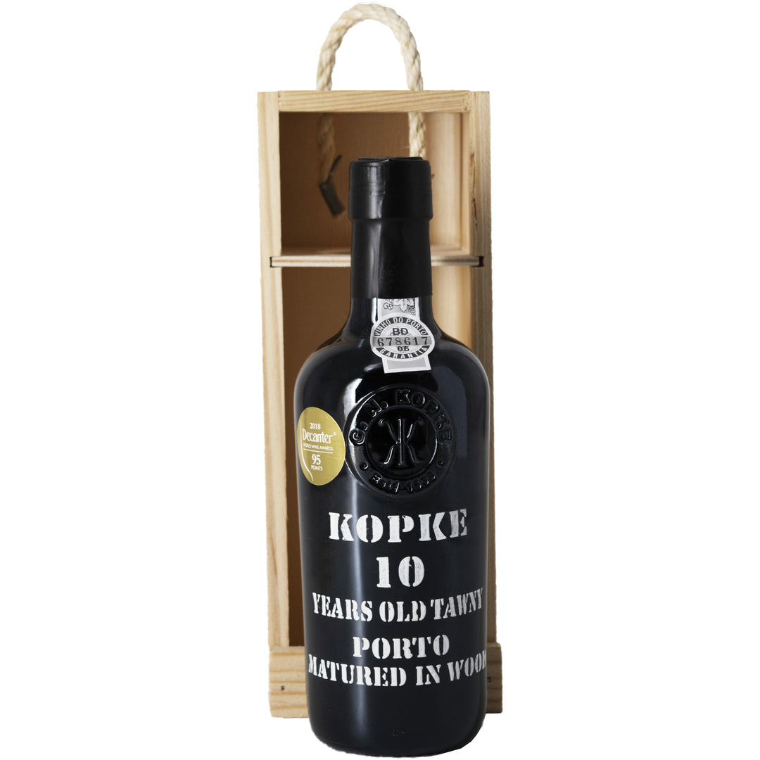 Kopke 10 Years Old Tawny Porto bottle in a wooden gift box, adorned with awards and classic black packaging.